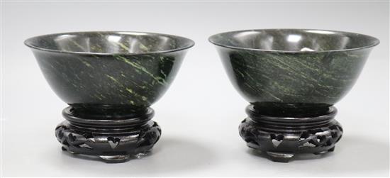 A pair of modern Chinese dark jade bowls with hardwood stands, boxed